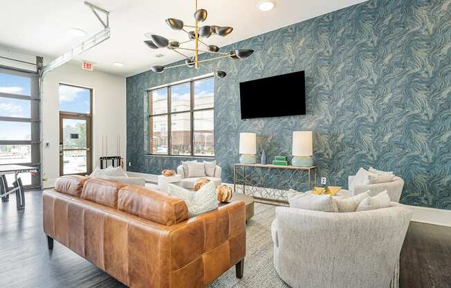 a living room with blue wallpaper and a large window