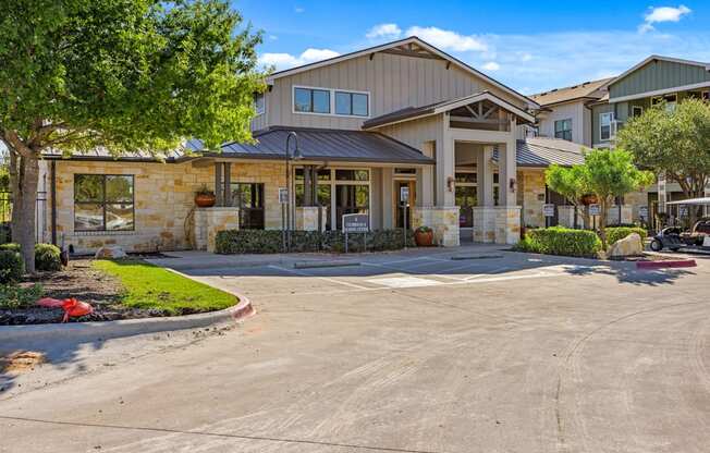 A large building with a parking lot in front. at Bridge at Southpark Meadows, Austin