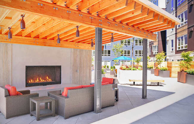 A patio with a fireplace and seating area. at Kirkland Crossing Apartments, Washington