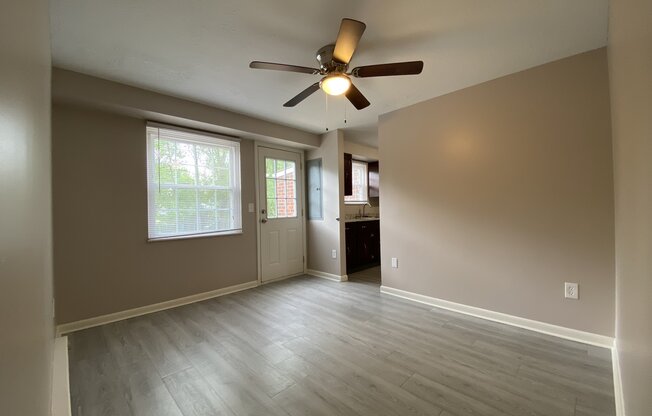 an empty dining room with a ceiling fan
