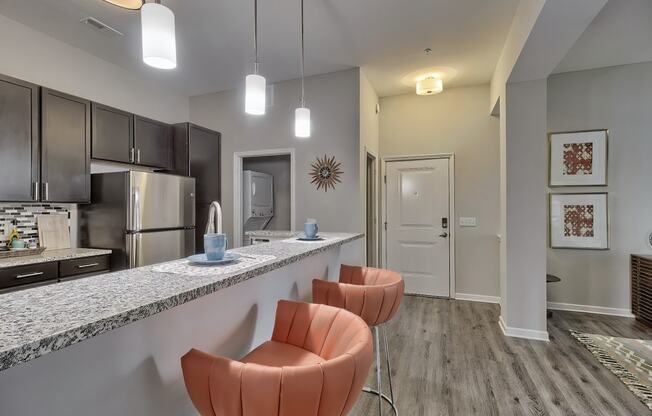 a kitchen with a long counter with chairs and a counter top at Nexus at Sandhill, South Carolina, 29229