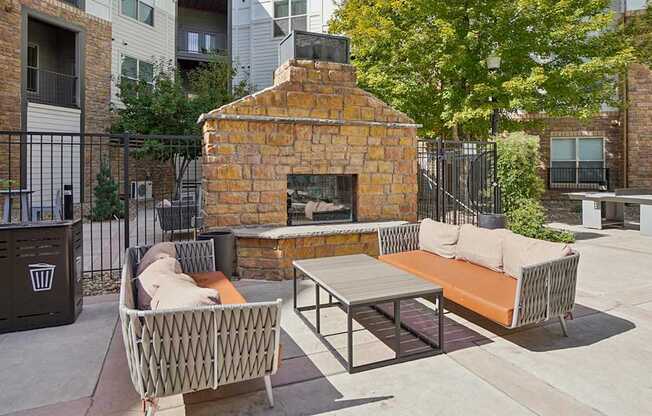 A patio with a fireplace and seating area.