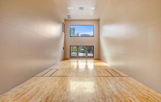 A long hallway with wooden floors and white walls.