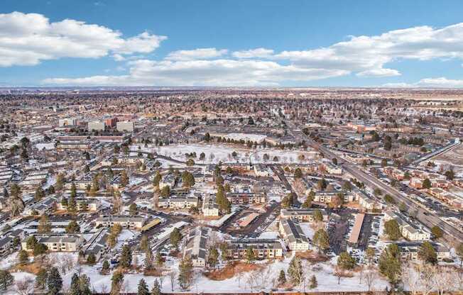 A cityscape with buildings and roads covered in snow.