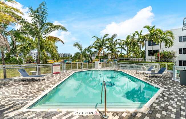 a swimming pool at a resort with palm trees