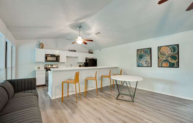 a living room with a kitchen and a dining table