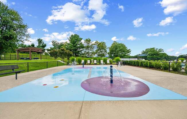 A splash pad with a large fountain in the middle.