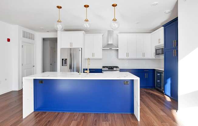 a kitchen with a blue island and white cabinets