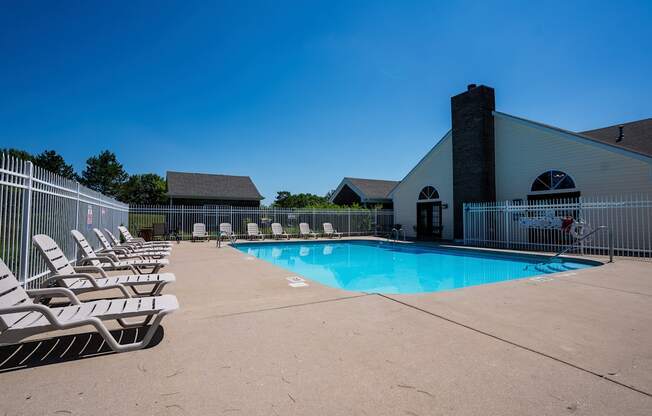 our resort style swimming pool is next to our building with lounge chairs