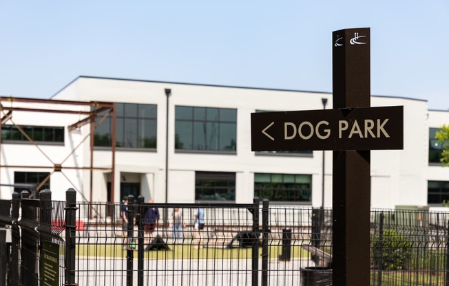 a dog park sign in front of a building