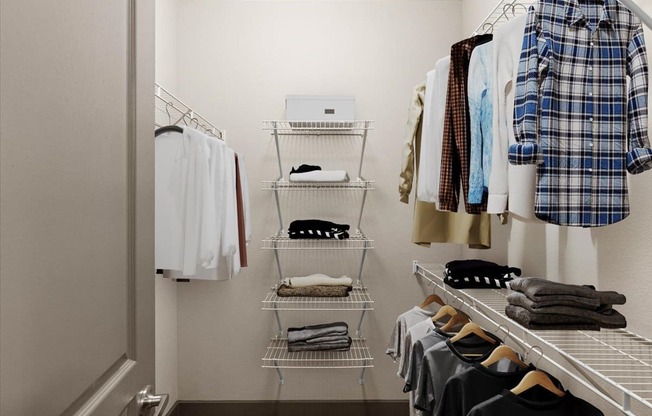 a walk in closet with white shelves and a white door