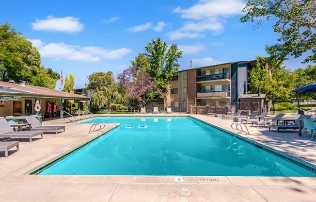 a swimming pool with a building in the background