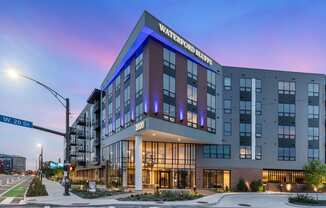 a large hotel building on a city street at dusk