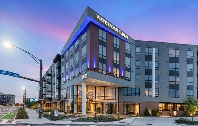 a large hotel building on a city street at dusk