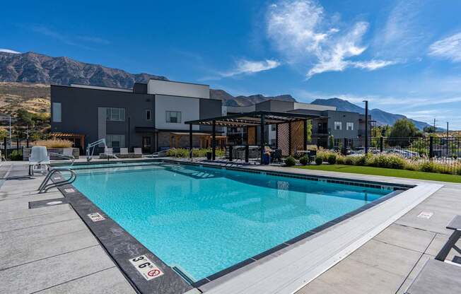 a swimming pool with a building in the background and a blue sky