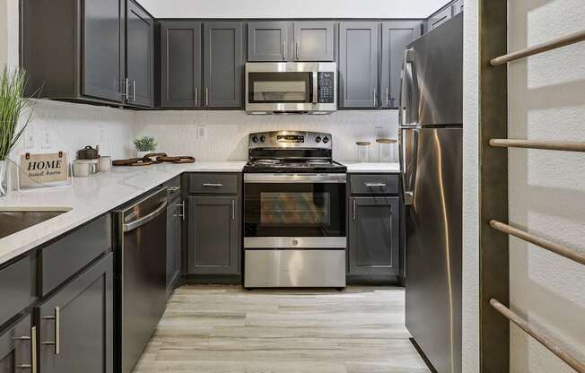 A kitchen with a stove, oven, and refrigerator.