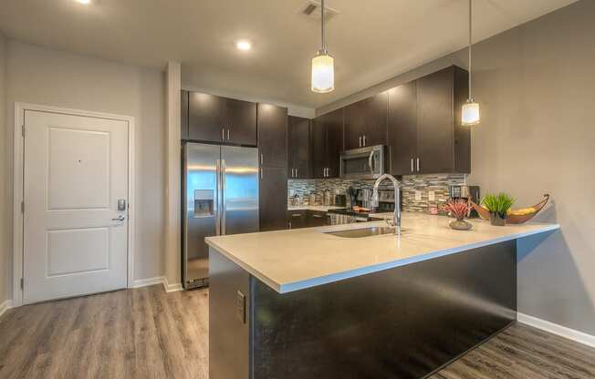 a kitchen with a large counter space and stainless steel appliances