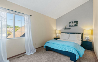 Experience tranquility in this elegantly designed bedroom, complete with plush bedding and natural light.