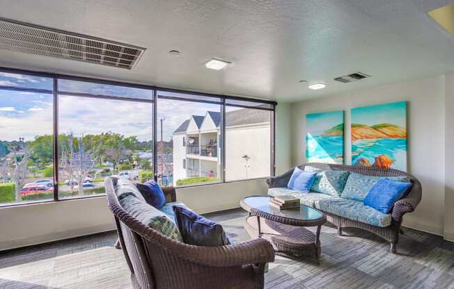 a living room with couches and a table and a window