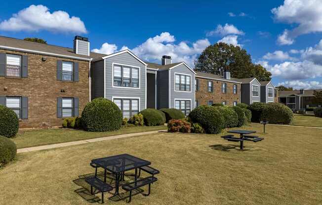 A sunny day at a residential area with a picnic table in the foreground.