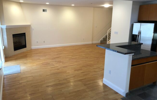 OPEN TOMORROW! Huge bi-level 3 bedroom 2.5 bath loft style apartment w/huge sunny yard, gas fireplace, remodeled kitchen, in-unit laundry and garage parking