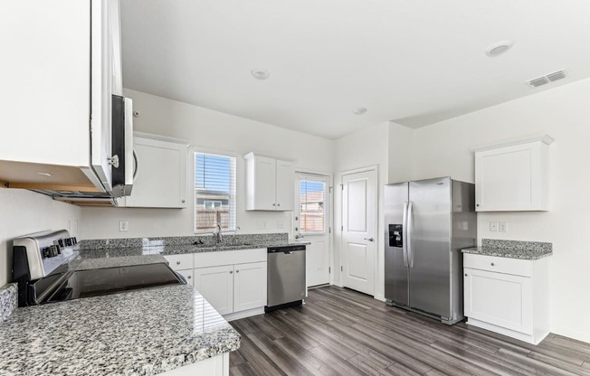 Modern kitchen at Dogwood home with stainless steel appliances at Beacon at Presidential Heights in Manor, TX