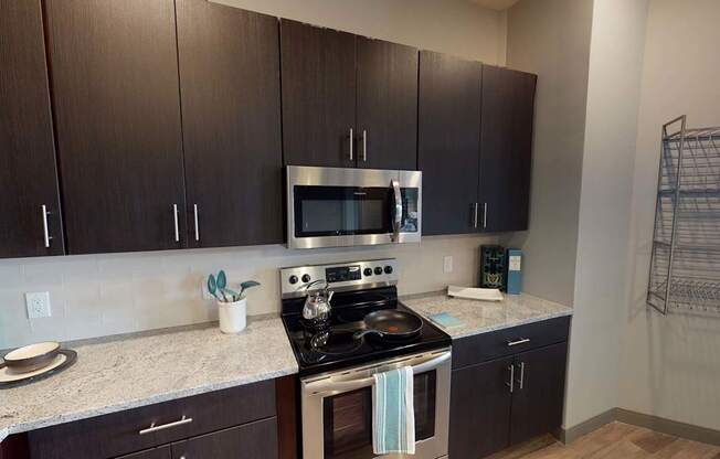 A kitchen with a stove top oven and microwave.