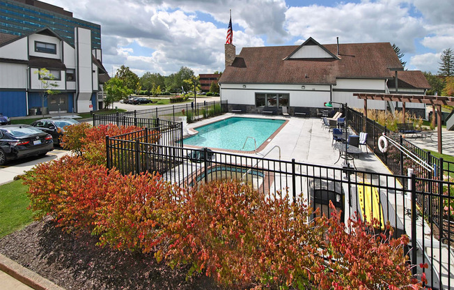 a swimming pool at a hotel with a building in the background