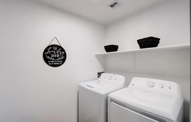 A laundry room with a washer and dryer.