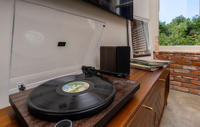 a vinyl record on a record player in a room with a window