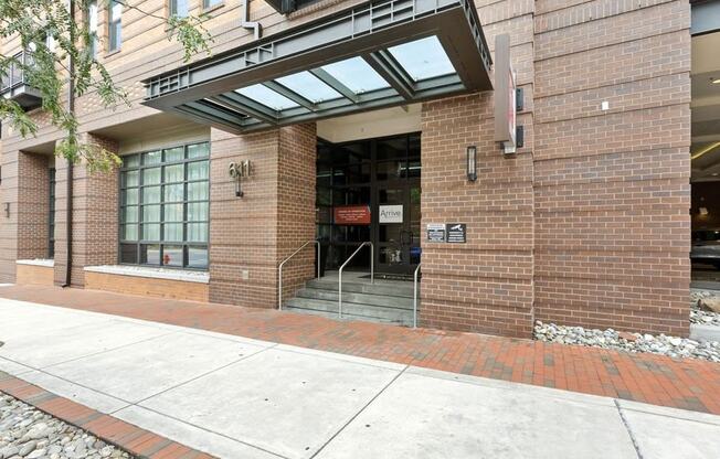 the entrance of a brick building with stairs