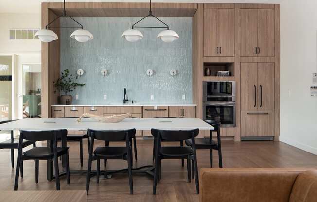 a dining room and kitchen with a large table and chairs