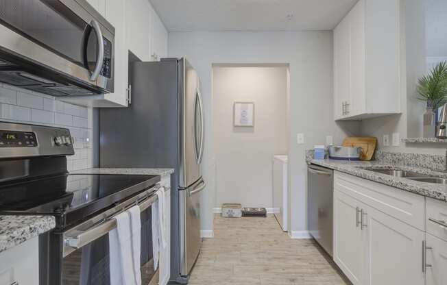 Model kitchen white cabinets, granite, stainless steel appliances