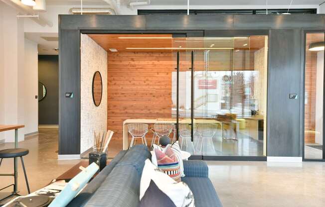 A modern living room with a couch and a skateboard on the floor.