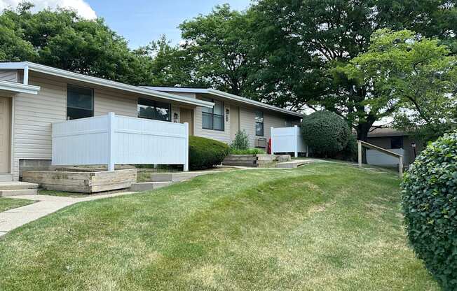 A grassy area in front of a row of houses.