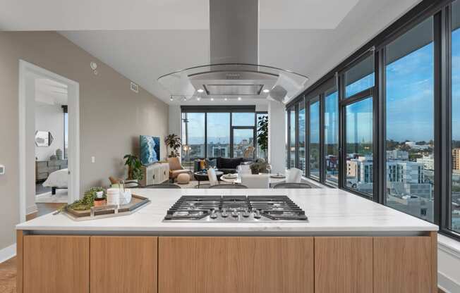 a kitchen with a large island and a view of a living room at Stanza Little Italy, California