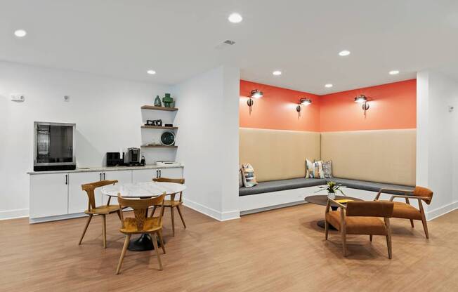 A kitchen with a dining table and chairs.