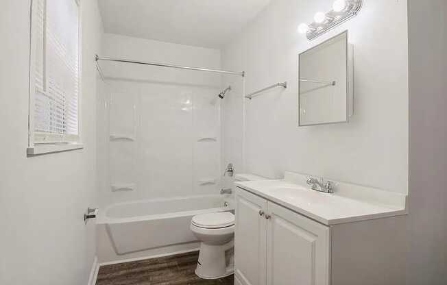 a bathroom with a toilet sink and bathtub