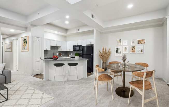 a living room and kitchen with a table and chairs