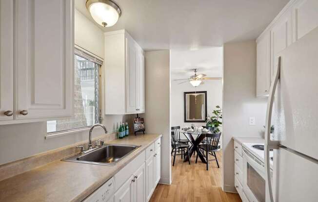 A kitchen with a table and chairs in the middle of the room.