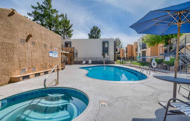 our apartments have a large pool and patio with umbrellas