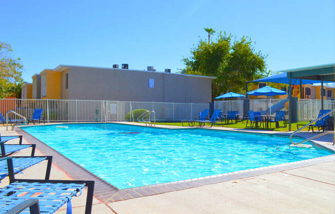 a swimming pool at a hotel with chairs and umbrellasat Summer  Meadows, Las Vegas