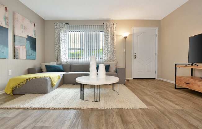 the model apartment living room with furnishings at The Oasis Daytona in Daytona Beach, FL