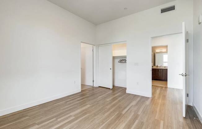 a living room with white walls and wood floors