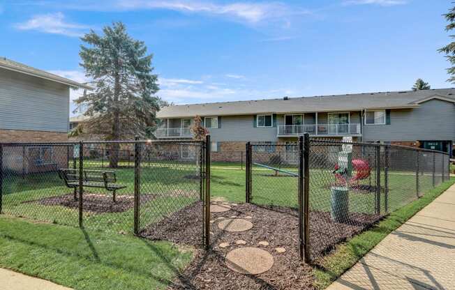 a fenced in yard with a house in the background