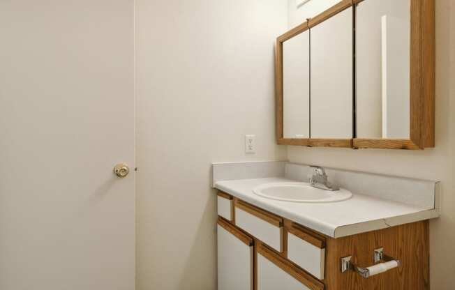 an empty bathroom with a sink and a mirror