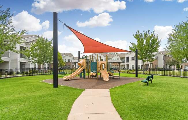 the preserve at ballantyne commons playground with play equipment and apartments in the background