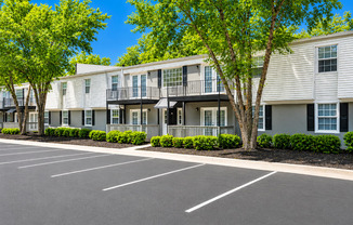 A parking lot in front of apartment buildings.