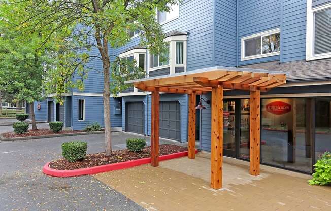 a wood archway in front of a blue building