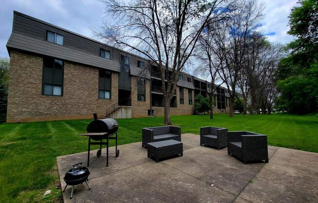 our apartments have a patio with seating and a grill